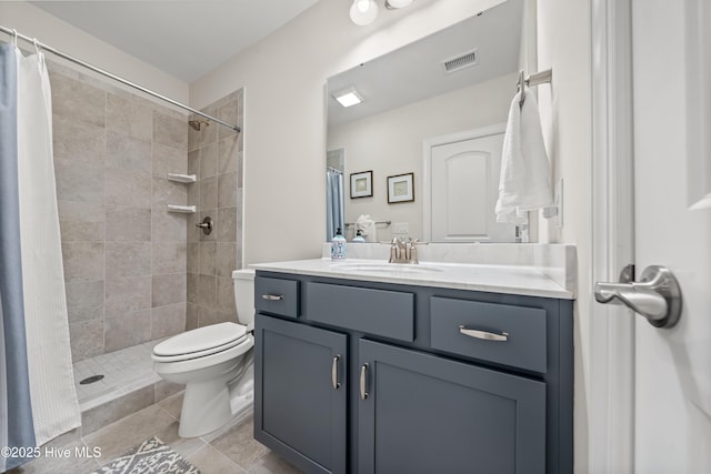 full bath with visible vents, tiled shower, toilet, and vanity