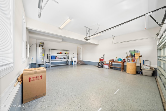 garage featuring a garage door opener and water heater