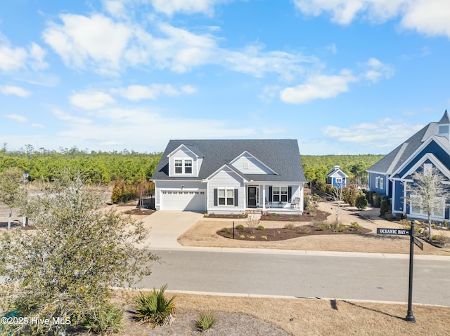 view of front of home with concrete driveway, a porch, and a garage