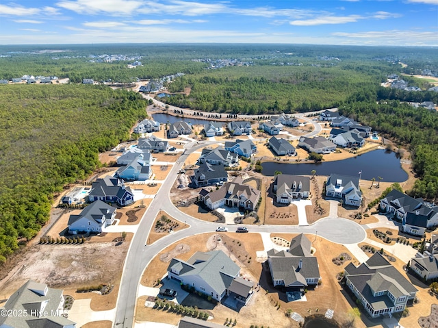 bird's eye view with a residential view, a water view, and a wooded view