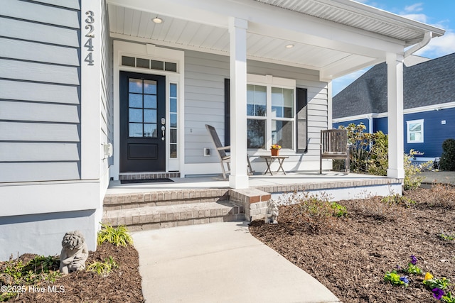 view of exterior entry featuring a porch