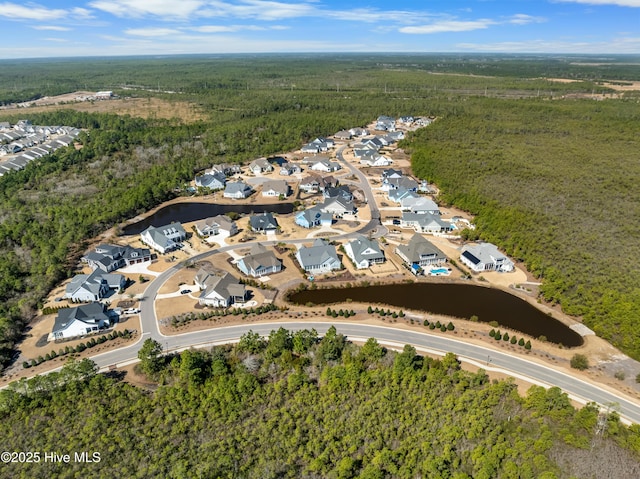 birds eye view of property featuring a residential view and a view of trees