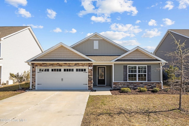 craftsman inspired home featuring stone siding, concrete driveway, a garage, and roof with shingles