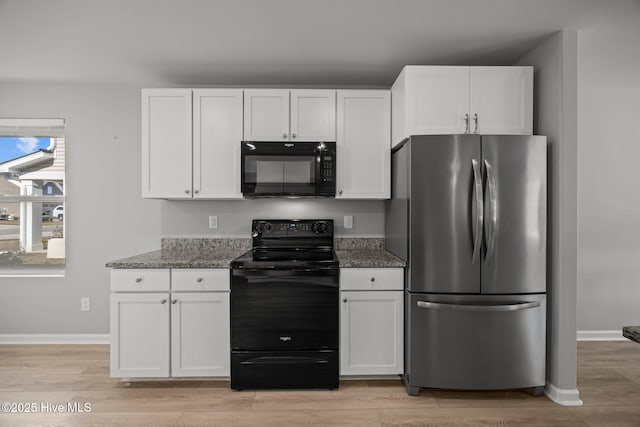 kitchen with black appliances, baseboards, light wood-style flooring, stone countertops, and white cabinetry