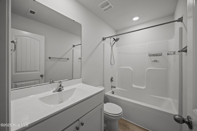 bathroom with vanity, toilet, bathtub / shower combination, and visible vents