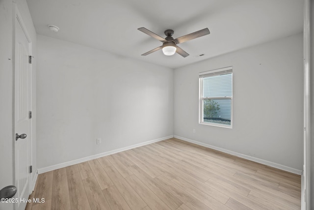 empty room featuring baseboards, light wood-style floors, and a ceiling fan