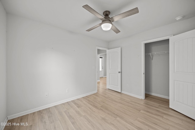 unfurnished bedroom featuring light wood-type flooring, baseboards, a closet, and a ceiling fan