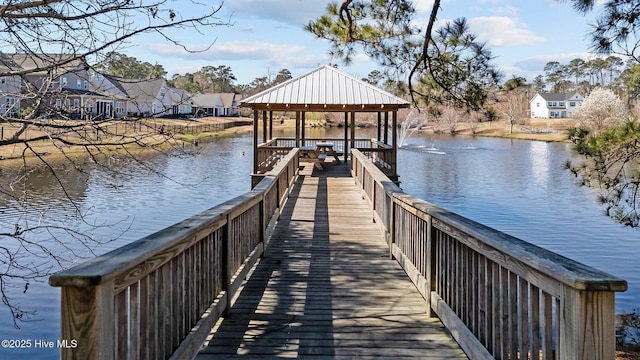 dock area with a gazebo, a residential view, and a water view