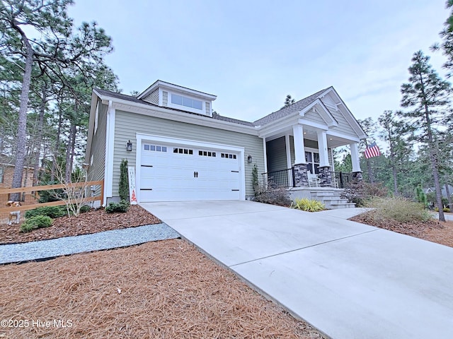 view of front of property featuring a garage, covered porch, and driveway