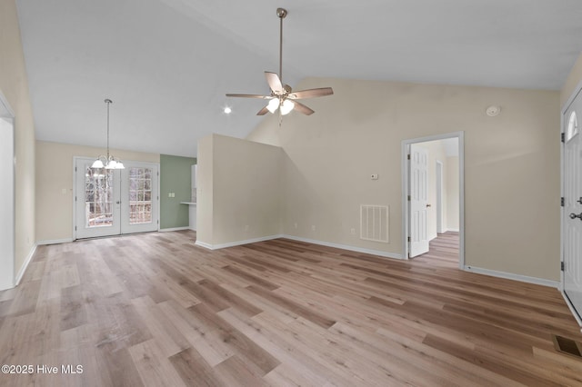 unfurnished living room featuring visible vents, ceiling fan with notable chandelier, baseboards, and light wood-style floors