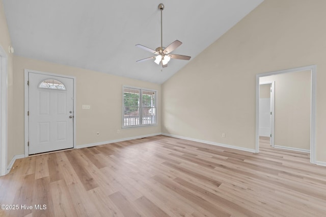 entryway featuring light wood-style flooring, a ceiling fan, baseboards, and high vaulted ceiling