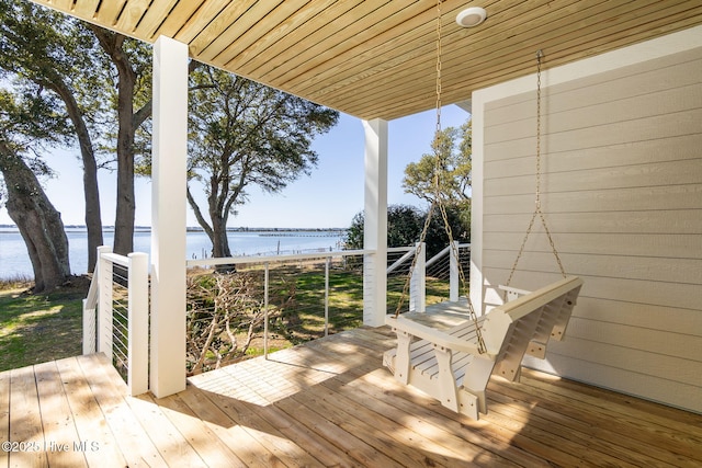 wooden deck featuring a water view