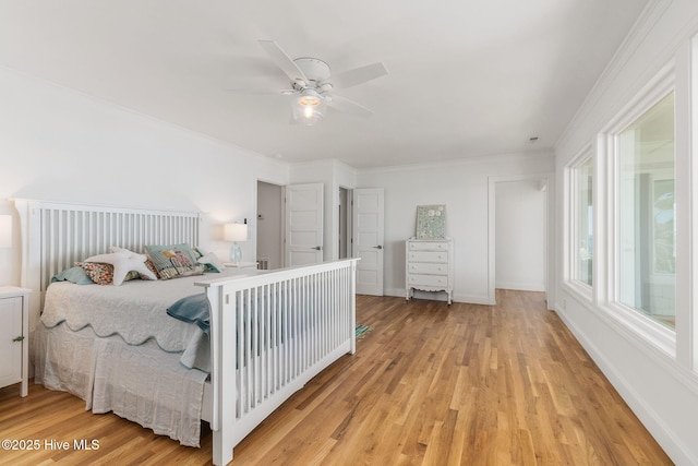 bedroom featuring baseboards, light wood-style floors, and ceiling fan