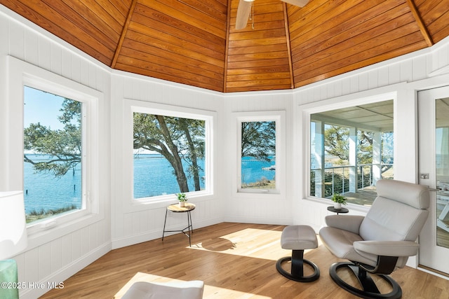 sunroom / solarium featuring a wealth of natural light, ceiling fan, and wooden ceiling