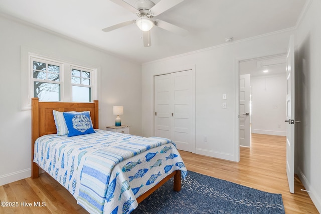 bedroom with a closet, baseboards, and light wood-style flooring