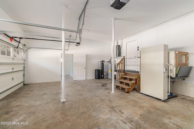 garage featuring a garage door opener and freestanding refrigerator