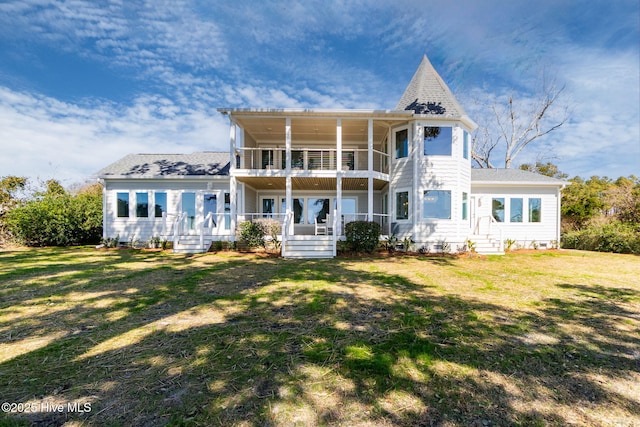 view of front of house featuring a front lawn, a balcony, covered porch, and roof with shingles