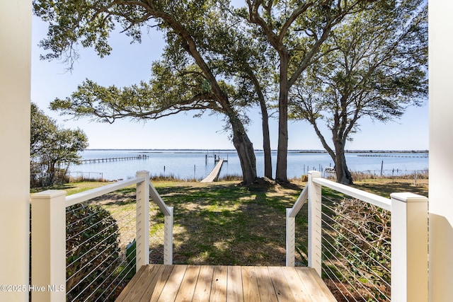 exterior space featuring a lawn and a water view