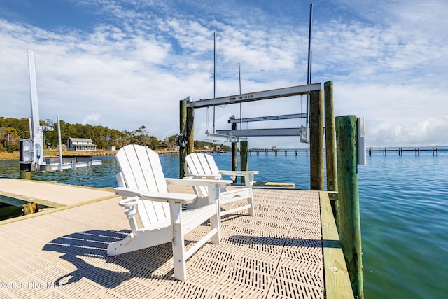 dock area with boat lift and a water view