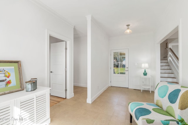 entrance foyer featuring stairway, baseboards, and ornamental molding