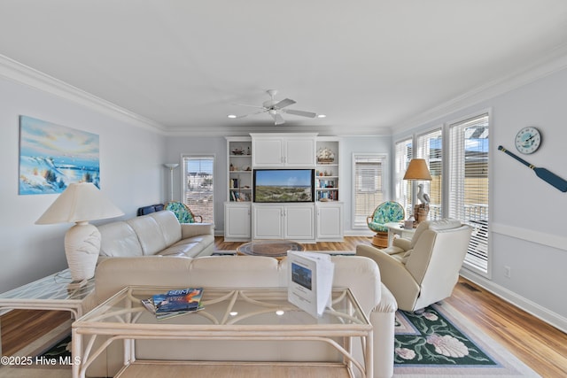 living room with light wood finished floors, plenty of natural light, and crown molding