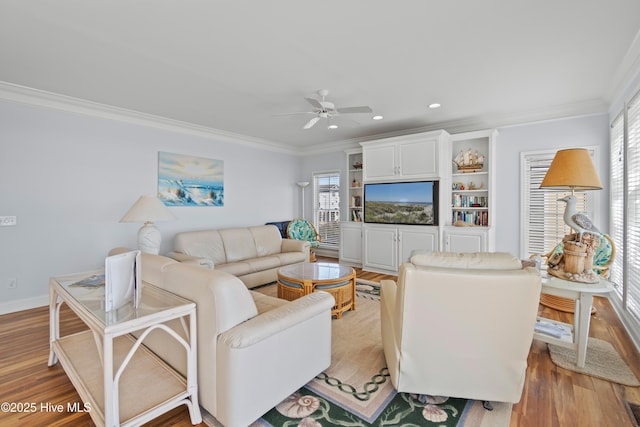 living room featuring crown molding, recessed lighting, light wood-style floors, and a healthy amount of sunlight