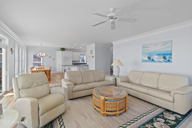 living room featuring crown molding, light wood-style flooring, and a wealth of natural light