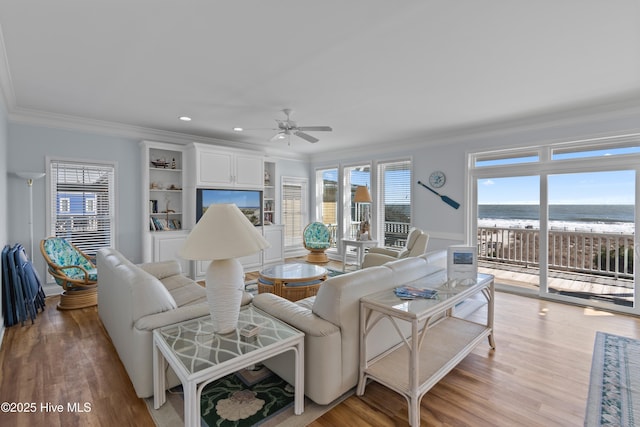 living room with crown molding, light wood-style flooring, recessed lighting, and a ceiling fan