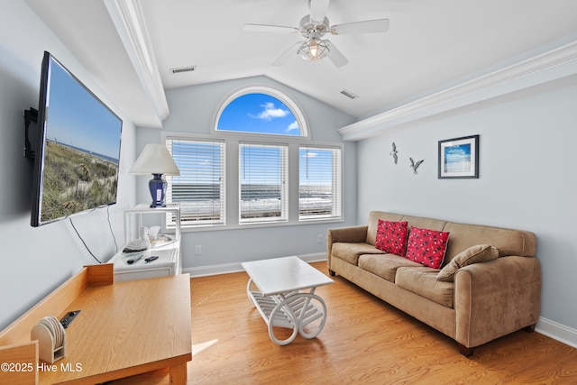 living area featuring vaulted ceiling, wood finished floors, baseboards, and visible vents