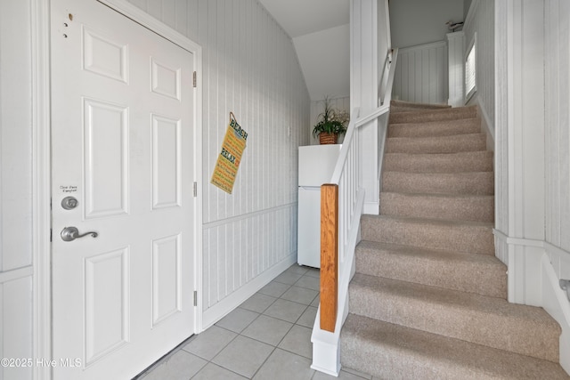 stairs featuring tile patterned flooring