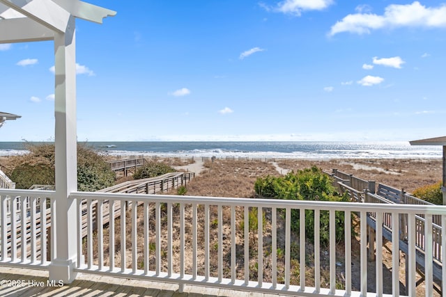 balcony with a beach view and a water view