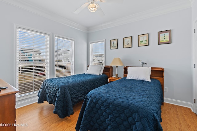 bedroom with ceiling fan, wood finished floors, baseboards, and ornamental molding