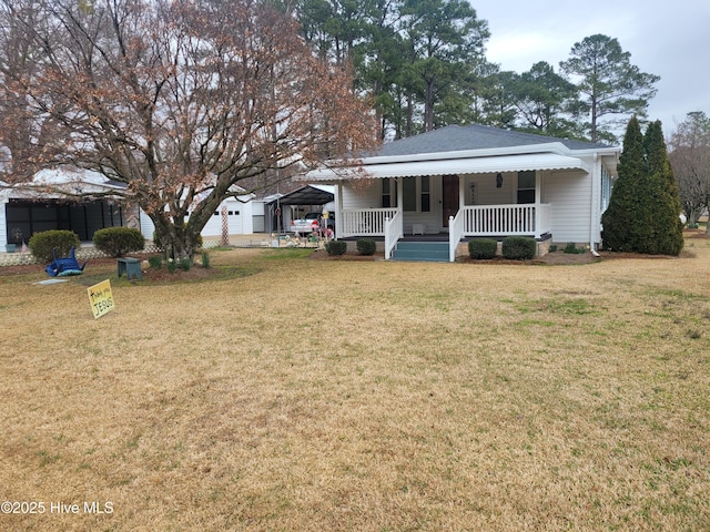 view of front of house featuring a carport, a porch, and a front yard