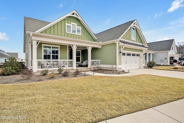 craftsman-style home with a front yard, driveway, an attached garage, covered porch, and board and batten siding