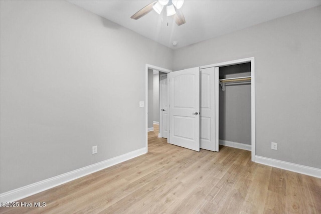 unfurnished bedroom with a closet, baseboards, a ceiling fan, and light wood finished floors