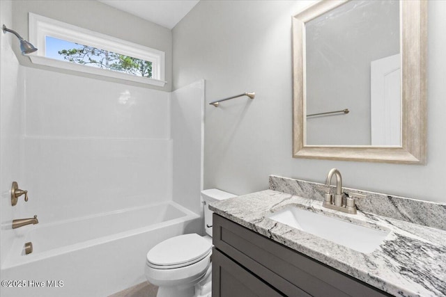 full bath featuring vanity, toilet, and washtub / shower combination