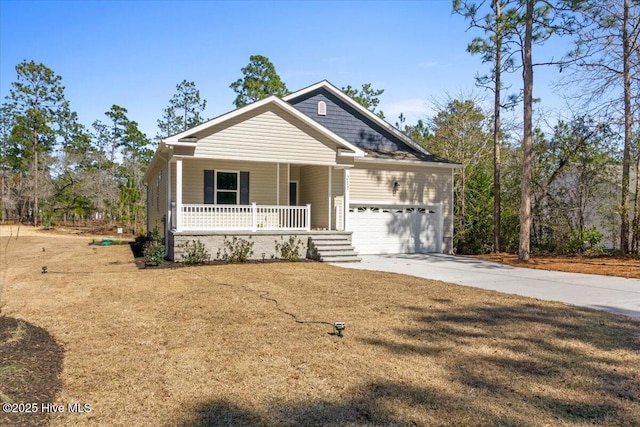 view of front of property featuring covered porch, concrete driveway, a garage, and a front yard