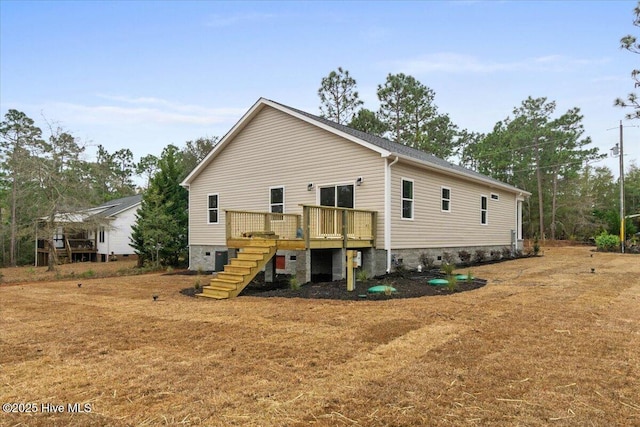 back of house with stairs, a deck, and crawl space