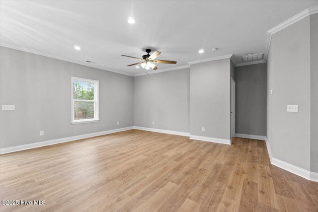 unfurnished room with visible vents, light wood-style flooring, baseboards, and ornamental molding