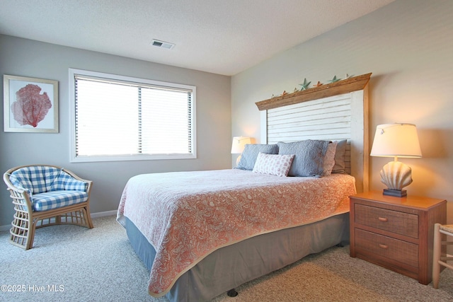 carpeted bedroom with baseboards, visible vents, and a textured ceiling