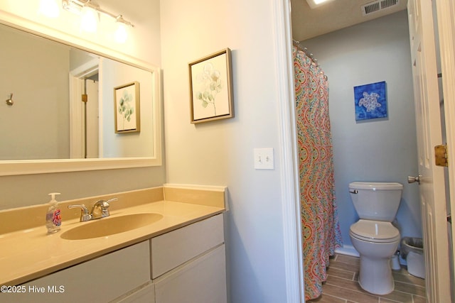 full bath featuring vanity, toilet, visible vents, and wood tiled floor