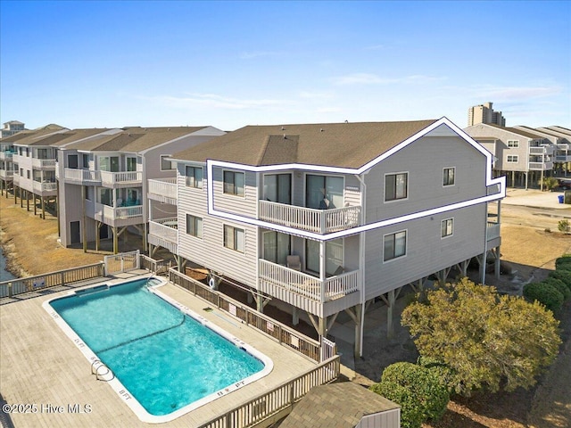 community pool with a patio area and a residential view