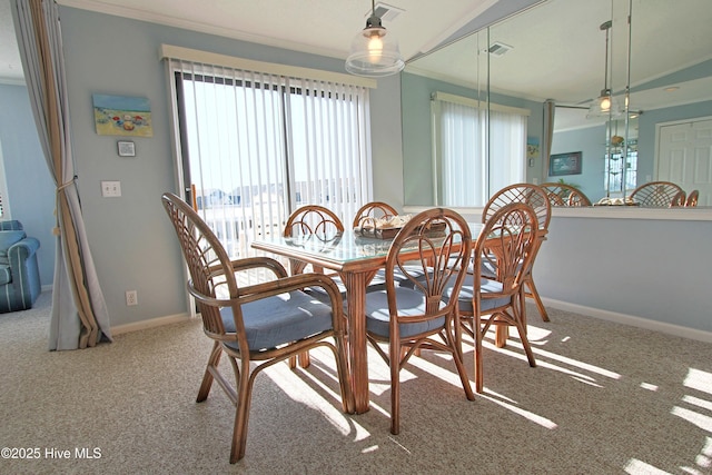 carpeted dining room featuring visible vents, baseboards, and ornamental molding