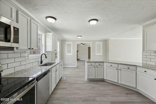 kitchen with a sink, electric range, dishwasher, and crown molding