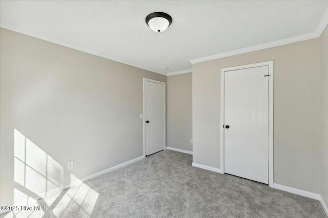 unfurnished bedroom with baseboards, carpet floors, and ornamental molding