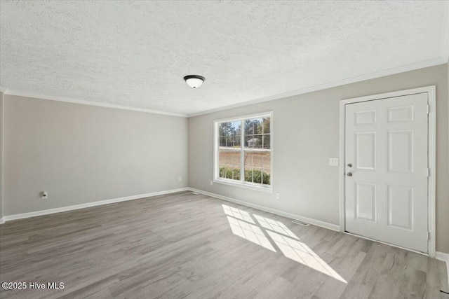 interior space with baseboards, wood finished floors, and ornamental molding