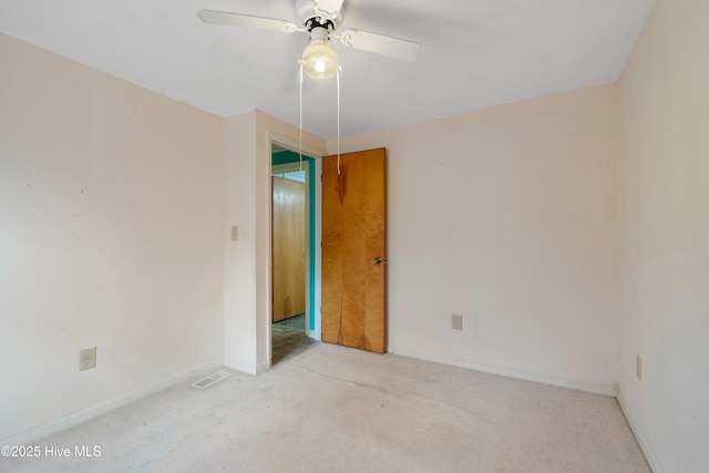 unfurnished room featuring visible vents, baseboards, ceiling fan, and carpet flooring