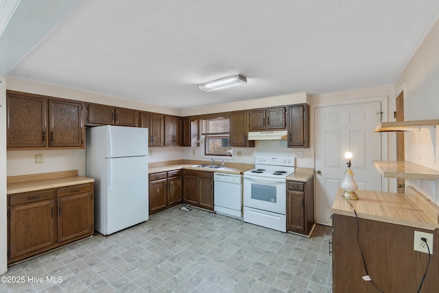 kitchen featuring white appliances, light floors, a sink, light countertops, and under cabinet range hood