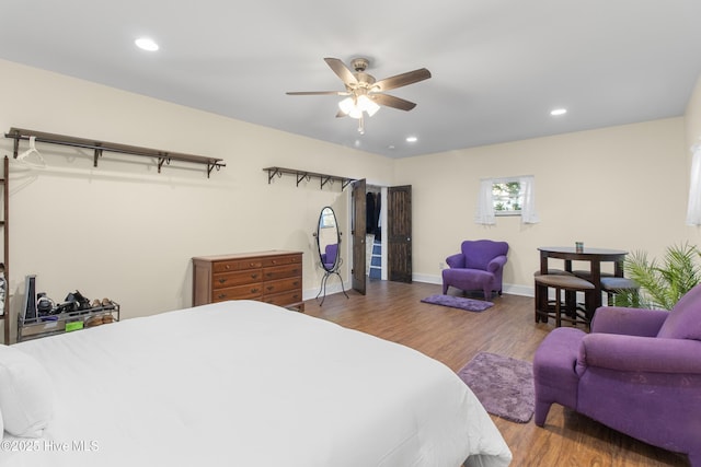 bedroom with wood finished floors, recessed lighting, baseboards, and ceiling fan