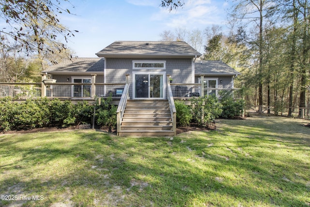 back of property with stairway, a wooden deck, and a shingled roof